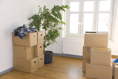 Packed moving boxes ready for transport in Churchend